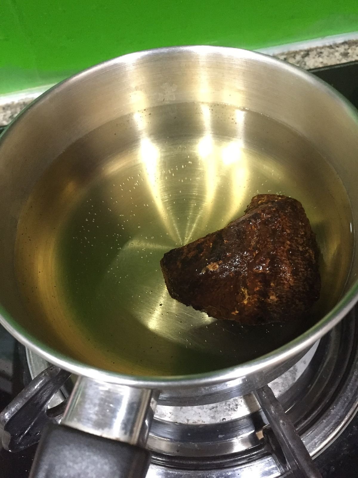 A cup of mushroom tea brewed from dried caps